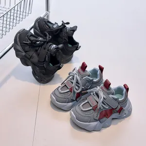 Detail view of children's thick-sole sneakers with velcro straps and anti-slip rubber outsoles