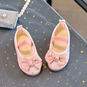 Pink sequin girls flats with large ribbon bow and elastic strap on starry fabric