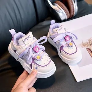 Detailed macro view of white and purple kids sneakers with decorative floral charms