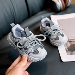 Detail of children's grey and white mesh sneakers with velcro and non-slip thick soles