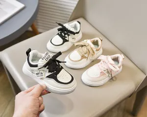 Détail de baskets pour enfants montrant trois couleurs en cuir synthétique à semelles