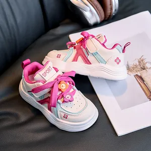 Detailed view of kids' leather sneakers with floral charms and blue pink accents