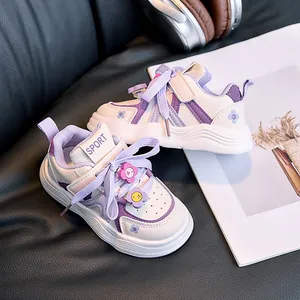Close-up of children sneakers with 3D flower charms and purple leather accents