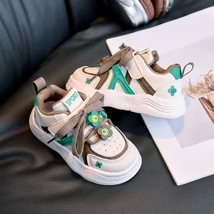 Detail view of children low-top sneakers with floral buckle and velcro strap