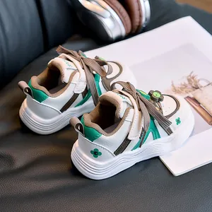 Detail of kids white sneaker with green flower pattern and velcro sport strap