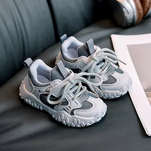 Close-up of lightweight kids sports sneakers with grey mesh and textured rubber sole