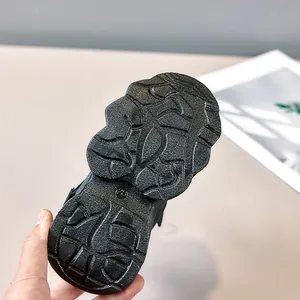 Detailed view of the anti-slip black rubber sole with size 28 and geometric grip pattern