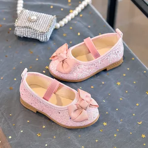 Detail of pink sequin girls Mary Jane shoes featuring a large ribbed bow and rubber sole