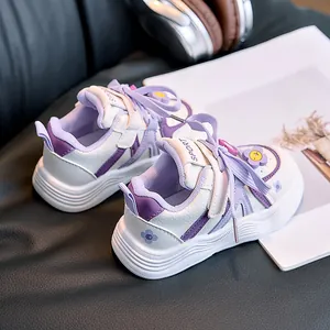 Detail view of purple kids' sneakers with floral patterns and non-slip soles