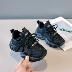 Detail of children's chunky sneaker with wave-pattern platform sole and velcro strap