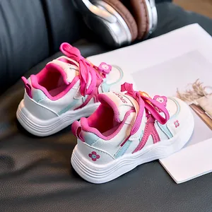Macro shot of durable non-slip wavy sole and floral details on girls' sport shoes