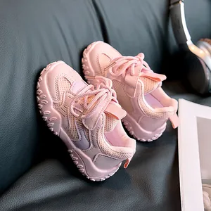 Detail of pink kids sneakers with breathable mesh fabric and wavy non-slip sole texture