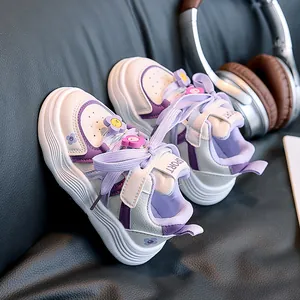 Detailed shot of white and purple kids sneakers with cute 3D floral accents and sport straps