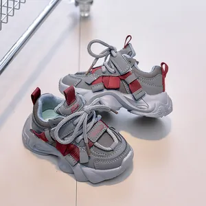 Detail view of children's grey sneakers showing mesh texture and hook-and-loop straps