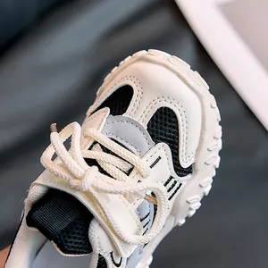 Close-up of kids' sneakers with breathable mesh, synthetic leather, and anti-collision toe