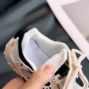 Close-up of children's sneakers featuring breathable mesh lining and a convenient heel pull tab
