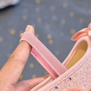 Macro view showing the high elasticity pink strap on sequin princess shoes for girls