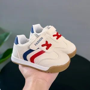 Détail de baskets pour bébé en cuir blanc avec velcro et semelle en caoutchouc