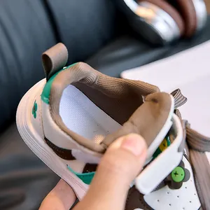 Close-up of children's low-top sneakers showing breathable fabric lining and padded heel