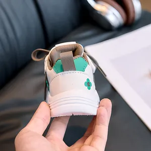 Close-up of kids sneaker heel with mint green accents and clover floral design
