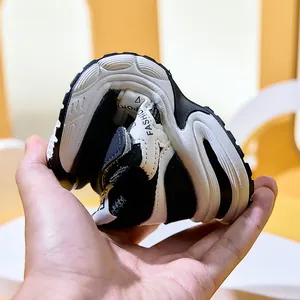 Detail of ultra-flexible rubber sole on breathable black and white kids sneakers