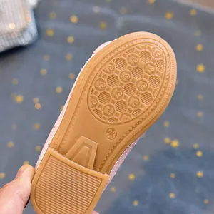 Detailed view of the brown anti-slip rubber sole with size 23 mark on girls' princess shoes