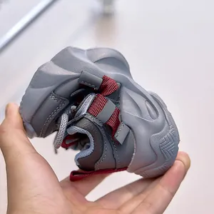 Detail showing the highly flexible and soft rubber sole of kids grey running shoes