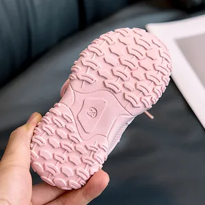 Detailed close-up of pink kids sneaker sole with anti-slip texture and size 23 mark