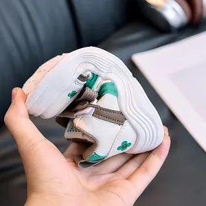 Close-up of flexible kids sneakers being bent to show the soft anti-slip rubber sole
