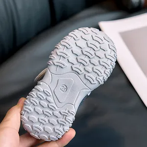 Detail of grey kids sneaker sole with wave anti-slip texture and size 23 engraving