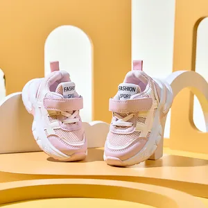 Close-up of pink and beige kids' breathable mesh sneakers with convenient velcro strap