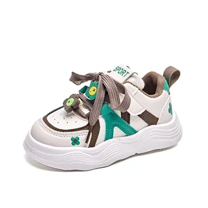 Kids' trendy low-top sneakers in white leather with green floral accents and soft soles