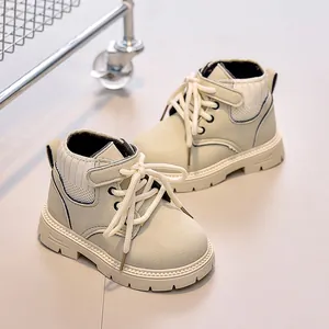 Detail of kids leather boots with knitted collar and non-slip rubber soles in beige