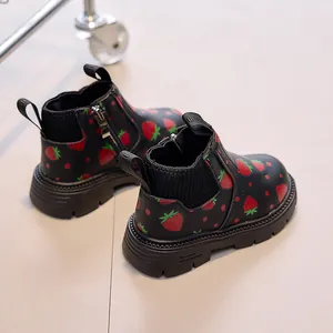 Detail of kids black strawberry martin boots showing side zipper and soft knit collar