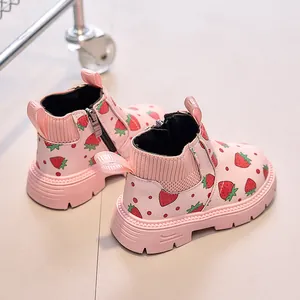 Detail of pink strawberry print kids boots with side zipper and knitted elastic cuff
