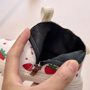 Detail of children's strawberry print boots featuring side zipper and mesh lining