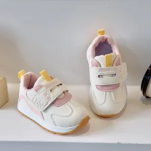 Detail view of toddler sneakers featuring velcro closure and cute rabbit cartoon pattern