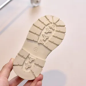 Detailed view of size 23 anti-slip rubber sole with deep grooves for toddler boots