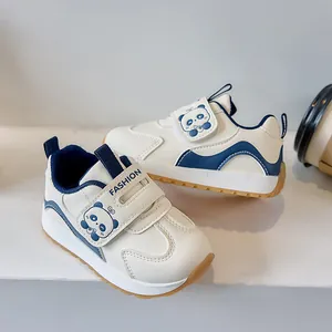 Detail of baby sneakers featuring dual velcro straps with blue cartoon panda pattern