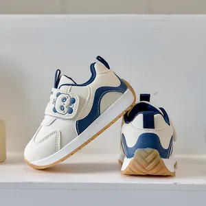 Detail of toddler sneakers with panda motif, velcro strap, and anti-slip rubber outsole