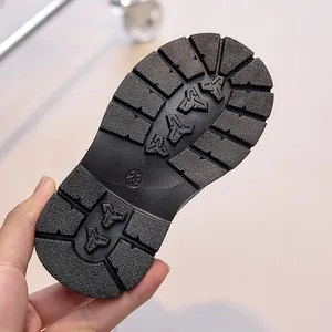 Close-up of durable rubber sole with deep anti-slip tread for kids boots size 23
