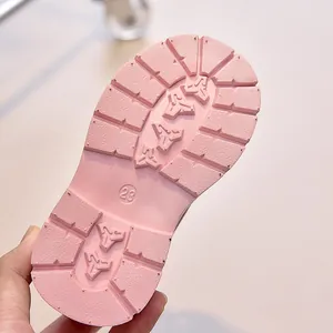 Detailed view of flexible rubber pink sole for kids boots with anti-slip tread and size 23 mark