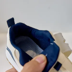 Detailed macro view of breathable insoles and gum rubber soles on infant sneakers