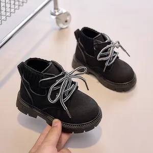 Detail of kids black suede martin boots showing soft texture and ribbed collar fabric