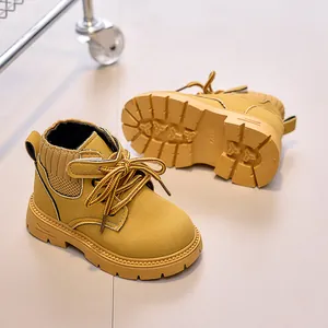 Detail of yellow kids boots showing non-slip rubber sole and knitted collar design