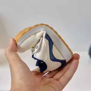 Close-up showing the flexible rubber sole of toddler sneakers bending for comfort