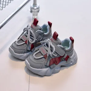Kids grey faux leather sneakers with red tape accents and anti-slip thick soles