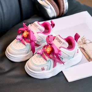 Kids low-top sneakers in white and pink with 3D flower charms and non-slip soles