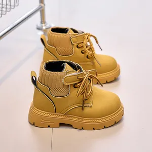 Detailed shot of yellow suede kids boots with knit collar and anti-slip rubber sole