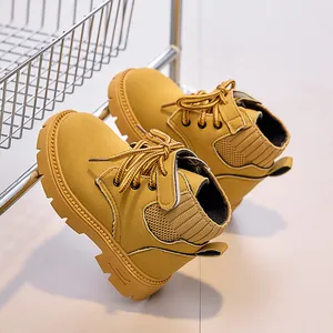 Detailed view of yellow nubuck leather kids boots with sturdy rubber outsoles